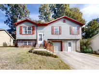Charming two-story home with gray siding, red trim, shutters, covered front entrance, and driveway at 1284 To Lani Path, Stone Mountain, GA 30083
