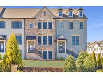 Beautiful townhome exterior with brick and painted siding, a welcoming entrance, and manicured landscaping at 1923 Skyfall Ne Cir, Atlanta, GA 30319