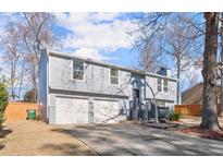 Charming two-story home with a two-car garage and well-maintained front yard at 1474 Harbins Rd, Norcross, GA 30093