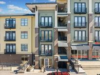 View of a modern apartment building with balconies and brick accents under a bright sky at 5300 Peachtree Rd # 3507, Chamblee, GA 30341