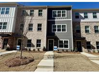 New construction townhome with brick and siding details and small front yard at 5455 Blossomwood Sw Trl, Mableton, GA 30126