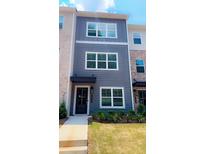Charming townhouse with a gray facade, manicured lawn, and neatly arranged landscaping at 5455 Blossomwood Sw Trl, Mableton, GA 30126