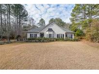 Charming single-story home featuring a well-manicured lawn and lush landscaping at 1183 Mountainside Drive Northwest Nw Dr, Kennesaw, GA 30152