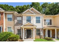 Inviting two-story townhome featuring mixed siding and manicured front lawn at 2838 Vining Ridge Ter # 0, Decatur, GA 30034