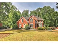Charming brick home featuring a well-manicured lawn and mature trees at 1290 Regency Center Sw Dr, Atlanta, GA 30331