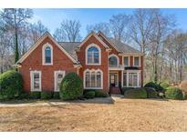 Charming brick home featuring manicured landscaping and traditional architectural details at 1290 Regency Center Sw Dr, Atlanta, GA 30331