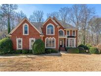 Charming brick home with a well-manicured front lawn and mature landscaping at 1290 Regency Center Sw Dr, Atlanta, GA 30331