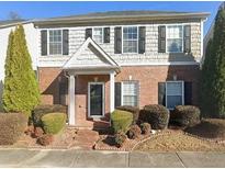 Charming brick townhouse featuring manicured landscaping and black shutters at 3272 Tiara Sw Cir, Atlanta, GA 30311