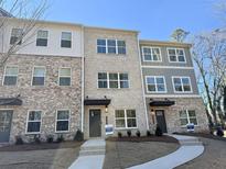 A stunning exterior view showcasing the townhome's brick facade and inviting entrance at 5447 Blossomwood Sw Trl, Mableton, GA 30126