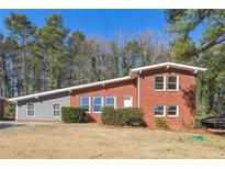 Charming brick home with a well-maintained lawn, perfect for families or those seeking a peaceful retreat at 3035 Mclendon Nw Cir, Atlanta, GA 30318