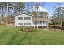 Charming two-story home with a well-manicured lawn and welcoming front porch at 322 Foxfire Sw Dr, Smyrna, GA 30082
