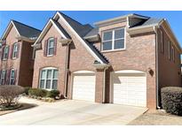 Brick home featuring a two-car garage, gabled roof, and manicured landscaping for enhanced curb appeal at 5066 Healey Dr, Smyrna, GA 30082