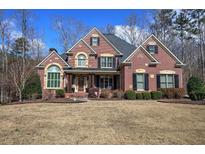 Stunning brick home with a well-manicured lawn and mature landscaping, evoking warmth and sophistication at 2139 Golden Morning Ct, Kennesaw, GA 30152