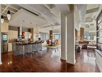 Bright open-concept living space with modern kitchen, dining area, and inviting living room with exposed duct work at 805 Peachtree Ne St # 614, Atlanta, GA 30308