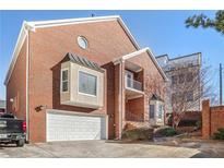 Well-maintained brick home featuring a garage, round window, and attractive architectural details at 409 Angier Ne Ct, Atlanta, GA 30312