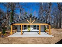 Charming home with a vibrant green door and exposed wooden beams on the covered front porch at 526 Myrtle St, Villa Rica, GA 30180