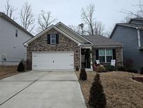 Charming brick home with a two-car garage and manicured front yard at 3593 Lachlan Dr, Snellville, GA 30078