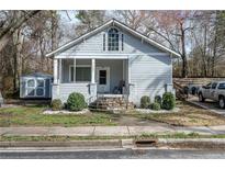 Charming home featuring updated light gray paint and a cozy front porch entrance at 4985 Union St, Union City, GA 30291