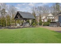 Spacious backyard with a charming outdoor kitchen, bar and gazebo at 1366 Kings Park Nw Dr, Kennesaw, GA 30152