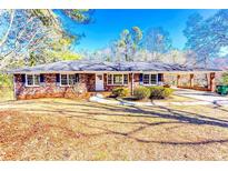 Charming brick home with a welcoming front yard and covered carport, perfect for outdoor living at 1650 Seayes Sw Rd, Mableton, GA 30126
