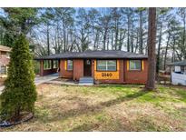 Charming brick home with lovely front lawn and convenient covered carport at 2140 Meador Se Ave, Atlanta, GA 30315