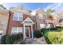 Charming brick townhome with manicured landscaping and inviting entryway at 2021 Austin Park Cir, Decatur, GA 30032