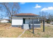 Charming single-story home featuring a covered front porch and a well-maintained, compact yard in a quiet neighborhood at 1820 Spring St, Conyers, GA 30012