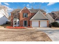 Charming two-story brick home featuring a well-manicured lawn and two-car garage at 4284 Hathaway Nw Ct, Kennesaw, GA 30144