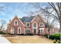 Beautiful brick home with mature landscaping and a welcoming front entrance at 2760 Sugarloaf Club Dr, Duluth, GA 30097