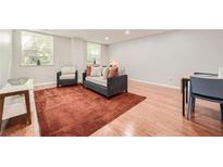 Bright living room featuring hardwood floors, windows, modern furniture and a vibrant rug at 2965 Pharr Court South Nw # 110, Atlanta, GA 30305