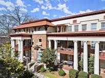 Stunning condo exterior with stately columns, balconies, and manicured landscaping at 746 N Highland Ne Ave # 11, Atlanta, GA 30306