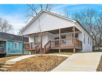 Charming home featuring a inviting porch, wooden railings, and a well-manicured lawn at 907 Oakhill Sw Ave, Atlanta, GA 30310