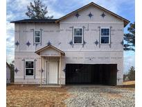 New construction home exterior view, showcasing the frame and windows against a blue sky at 147 Silverton Dr, Dacula, GA 30019