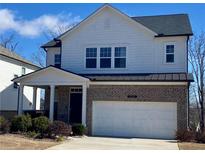 Charming two-story home with a brick facade, attached garage, and well-maintained landscaping at 5345 Coltman Dr, Cumming, GA 30028