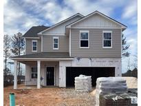 New two-story home with gray siding, white trim, and an attached two-car garage at 127 Silverton Dr, Dacula, GA 30019