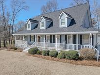 Charming two-story home features a welcoming full front porch and dormer windows at 3179 Meadow Trl, Loganville, GA 30052