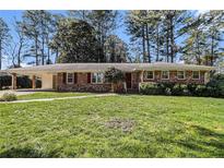 Charming brick home with a well-maintained lawn and a convenient covered carport at 2436 Hazelwood Ne Dr, Atlanta, GA 30345