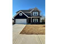 Charming two-story home featuring a two-car garage, stone accents, and inviting front porch at 11204 Cornerstone Way, Hampton, GA 30228