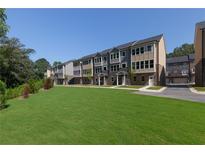 View of the new townhomes with green grass at 3806 Jack Vernon Cir, Powder Springs, GA 30127