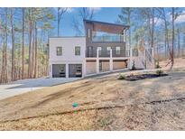 Contemporary two-story home with a two-car garage and a striking architectural design at 5292 Greenway Dr, Villa Rica, GA 30180