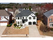 Beautiful two-story home with a black and white color scheme and well-manicured lawn at 5004 Duxford Se Dr, Smyrna, GA 30082