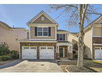 Charming two-story home with a stone-accented facade and two-car garage at 5430 Falls Landing Dr, Cumming, GA 30040