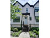 Charming townhome featuring light blue door, black trim windows, and well-maintained front landscaping at 3186 Kincaid Dr, Decatur, GA 30033