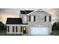 Charming two-story home featuring a brick facade, black shutters, and an attached two-car garage at 5305 Tolar Rd, South Fulton, GA 30213