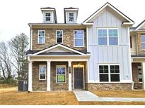 Charming two-story home with stone and siding, a covered porch, and well-manicured lawn at 4853 Walkers Green, Mableton, GA 30126