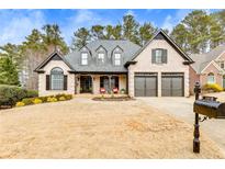 Charming brick home with a well-manicured lawn, black shutters, and a two-car garage at 5810 Ripplestone Nw Ct, Acworth, GA 30101