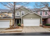 Charming townhome features a two-car garage and colorful, stylish exterior siding at 6000 Suttles Drive Sw, Atlanta, GA 30331