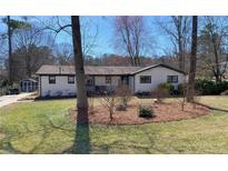 Charming ranch-style home with a beautifully landscaped front yard and a well-maintained lawn at 170 Dillard Ne Dr, Kennesaw, GA 30144