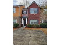 Charming townhome featuring brick and stone facade, complemented by well-maintained landscaping at 2612 Halligan Pointe, Riverdale, GA 30296