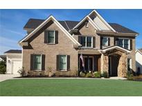 Charming two-story brick home with well-maintained lawn, black shutters, and stone-accented entrance at 2903 Eva Clb, Acworth, GA 30101